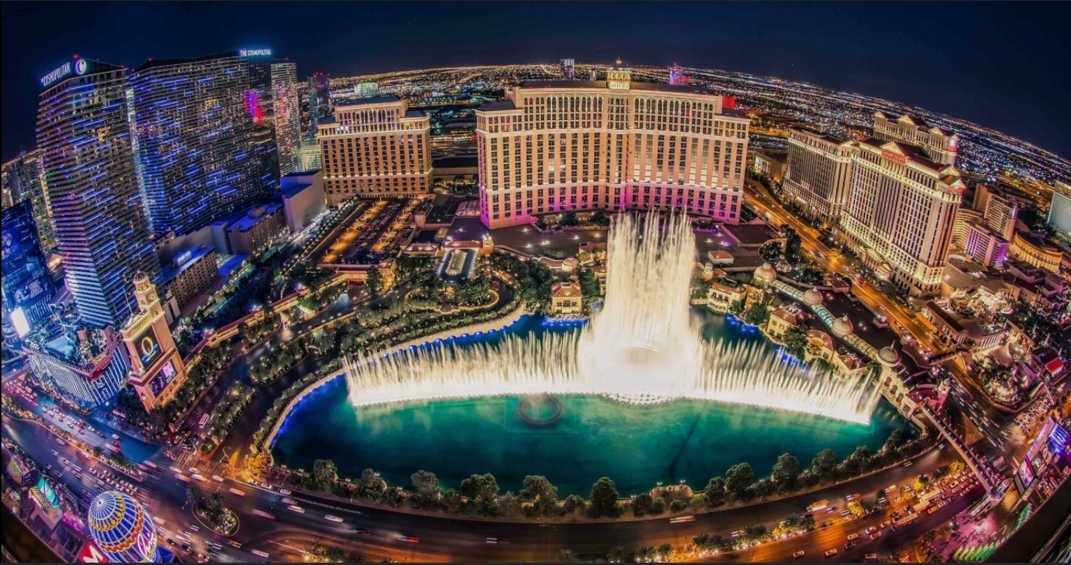 Las Vegas à noite, com as fontes do Bellagio e os hotéis iluminados